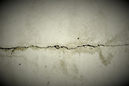 macro shot of cracked white concrete wall