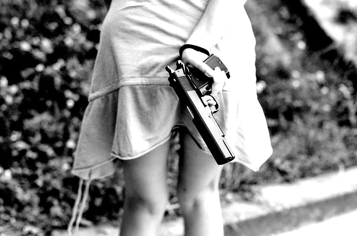 girl holding semi-automatic pistol