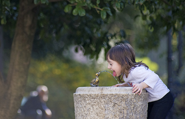girl's drinking on water fountain