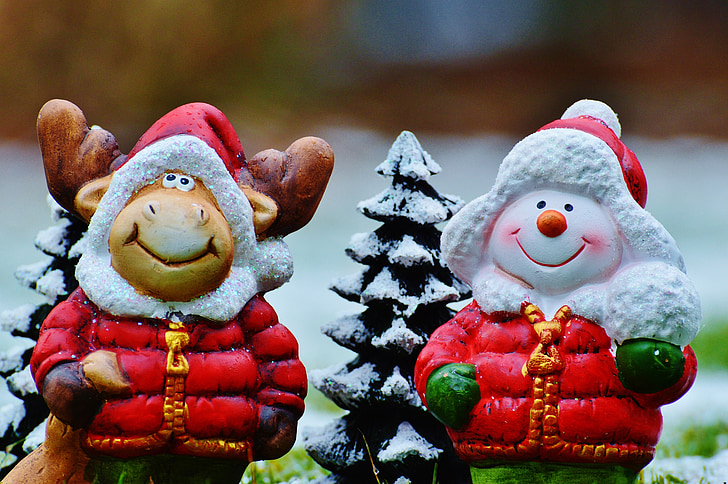 two snowman and reindeer with jacket figurines