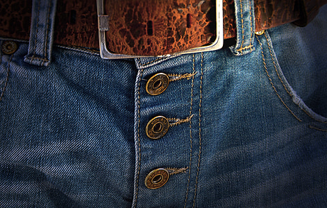 closeup photo of denim bottoms with brown belt