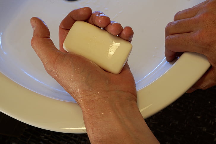 closeup photo of person holding bar soap