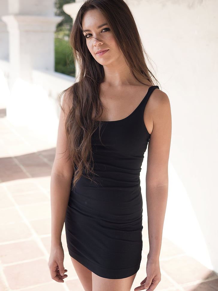 photo of woman wearing black sleeveless dress