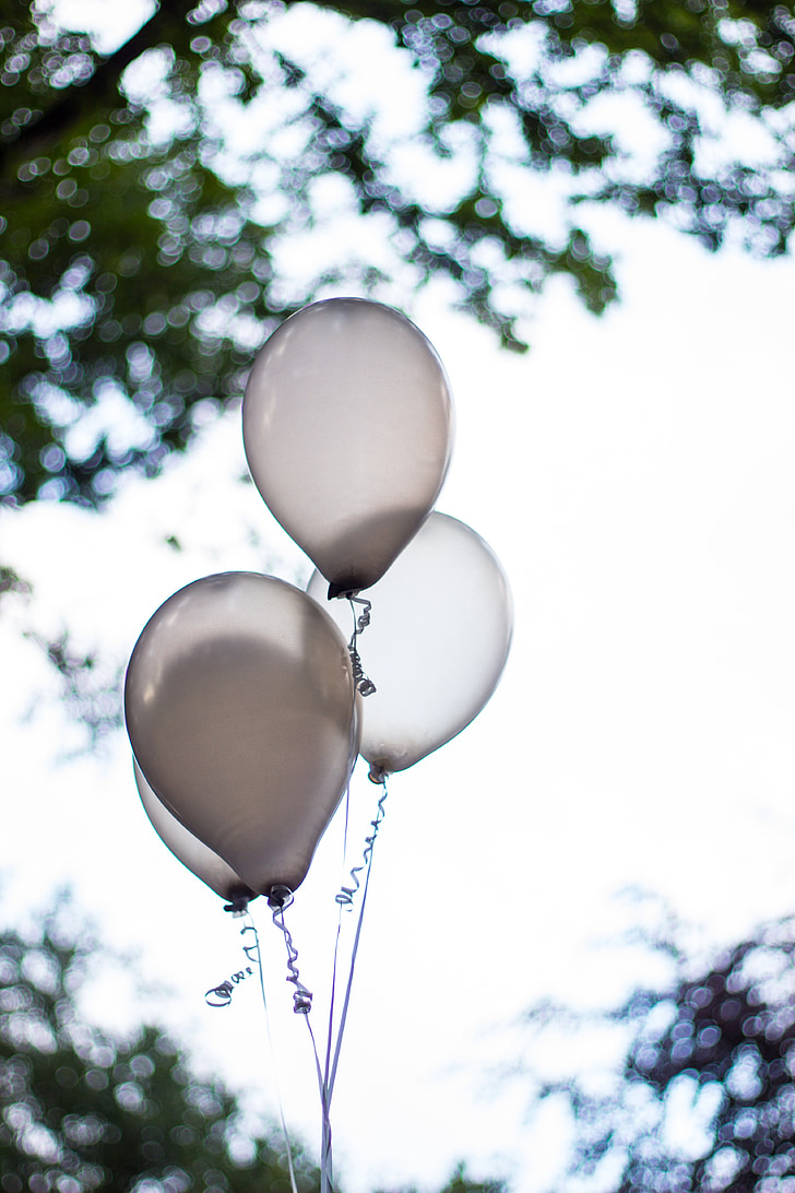 four white balloons on selective focus photo