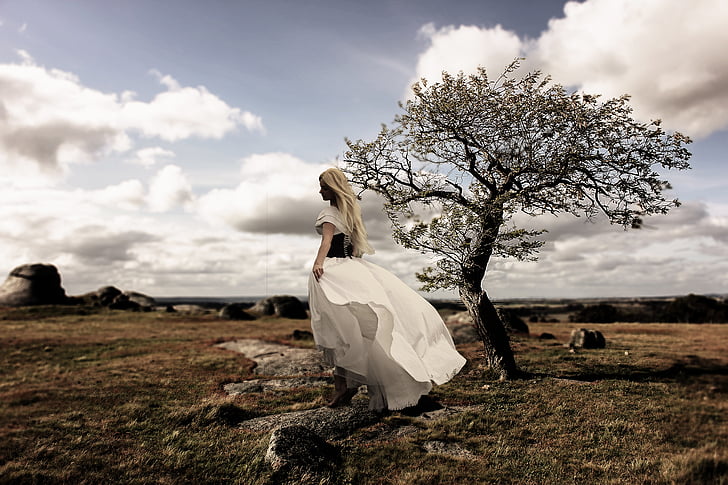 woman in white dress in the middle of the field