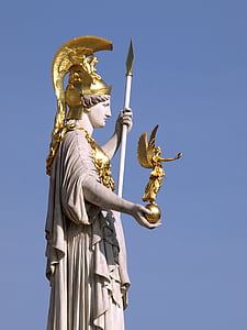 man holding spear statue under sunny sky