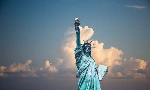 statue of Liberty under cloudy blue sky during daytime
