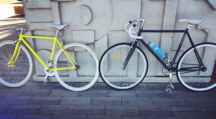 photo of two yellow and black single-speed bikes