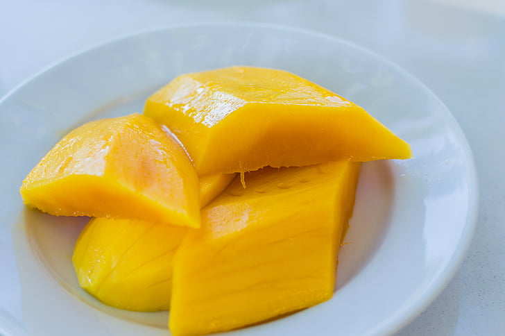 sliced mango fruit on white plate