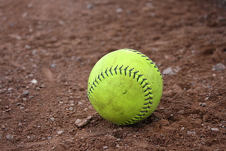green baseball on brown soil