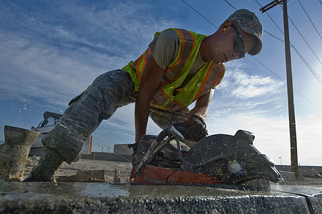 man cutting concrete