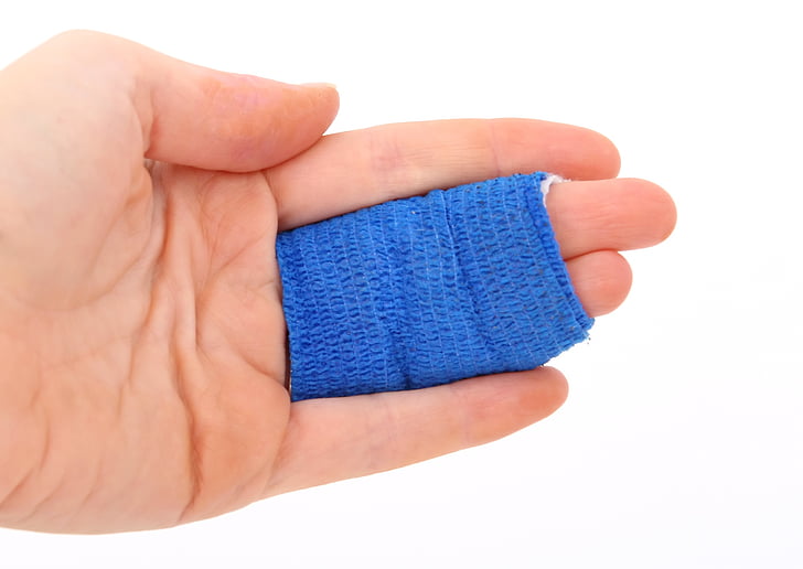 person with blue bandage on two fingers