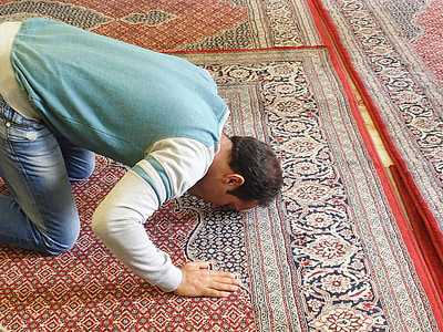 man kneeling on area rug