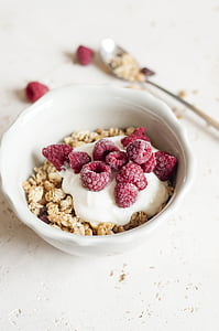 cereal with cream and red raspberries