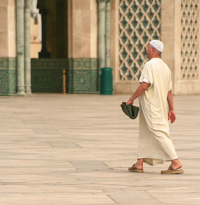monk walking on white floor