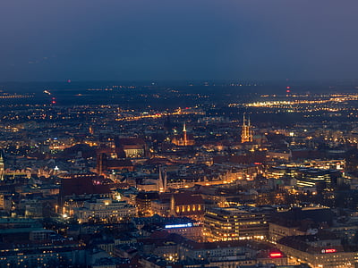 aerial view of buildings with lights during nighttime