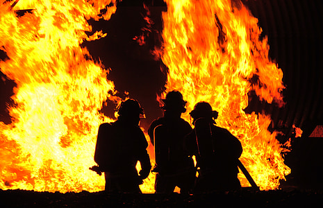 silhouette of men near fire