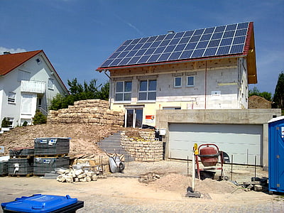 white concrete house with solar panel roofing