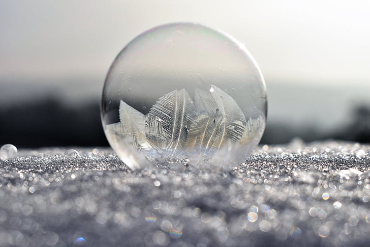 depth photography of clear glass ball