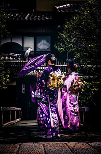 woman wearing purple dress under open umbrella photo