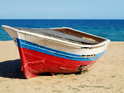 white, blue, and red jon boat in beach