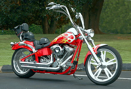 red and black chopper motorcycle on road