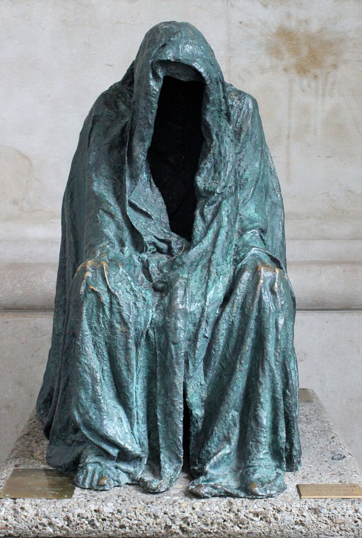 person wearing gray coat statue