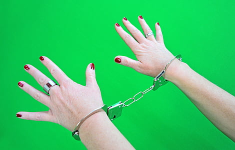 person wearing gray metal handcuff