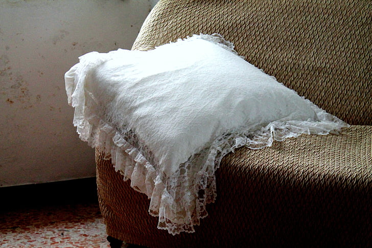 white throw pillow on sofa