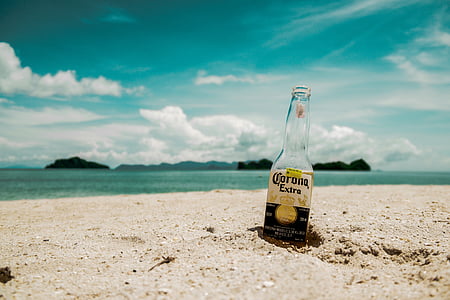 Corona Extra beer bottle on beach during daytime
