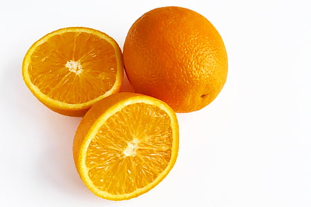 one whole and one sliced orange fruits