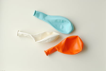 blue, white, and orange balloons with white background