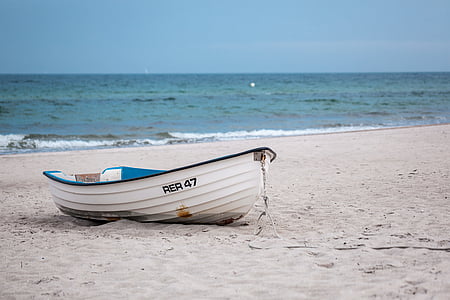 white canoe in beach
