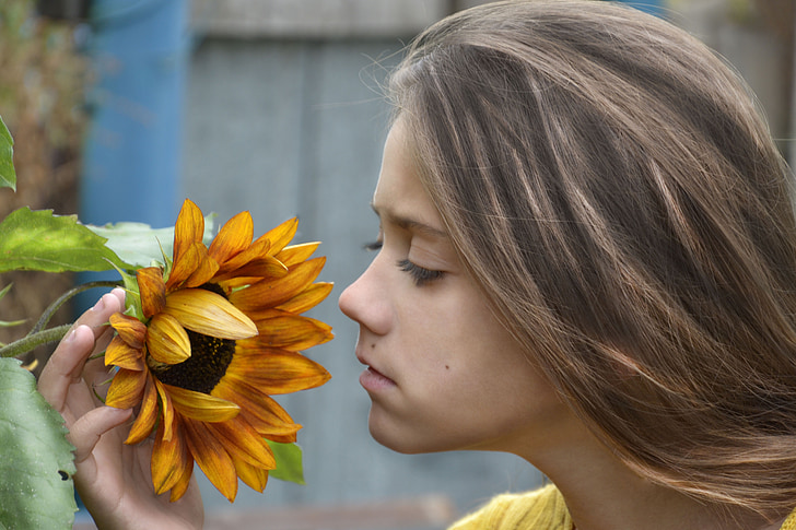 girl holding sunflower