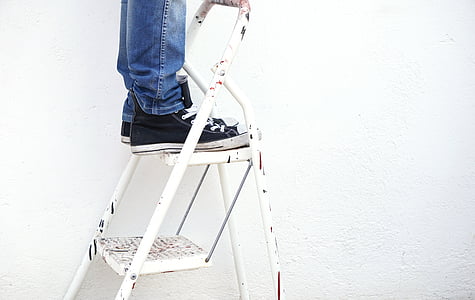 person standing on a frame ladder