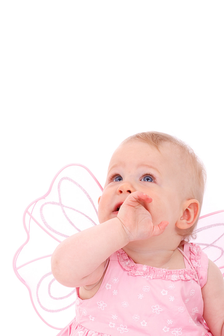 baby wearing butterfly wing eating hand photo