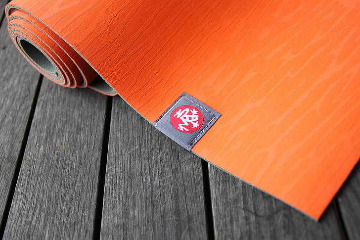 red yoga mat placed on gray board