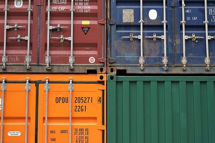 four assorted-color intermodal containers