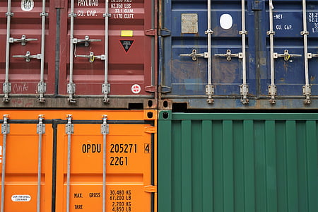 four assorted-color intermodal containers