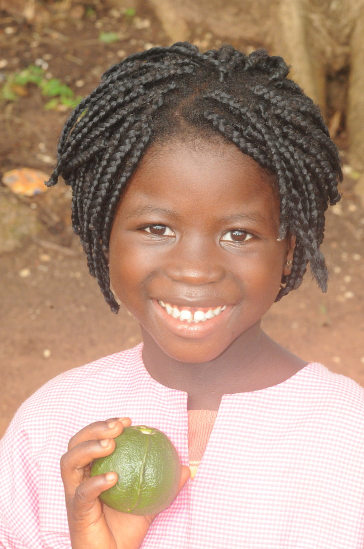 girl holding brown fruit