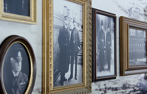 four photo frames of soldiers on wall