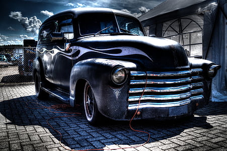 classic black vehicle on gray road