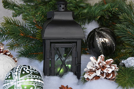 black candle lantern and Christmas baubles