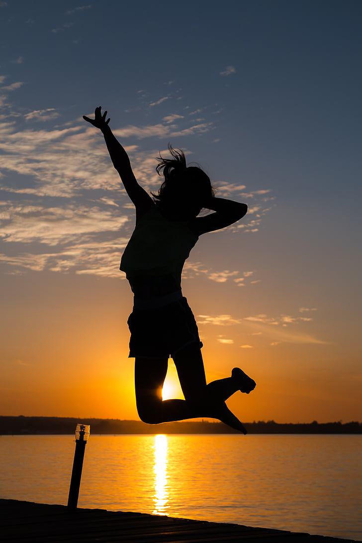 silhouette of woman white jumping