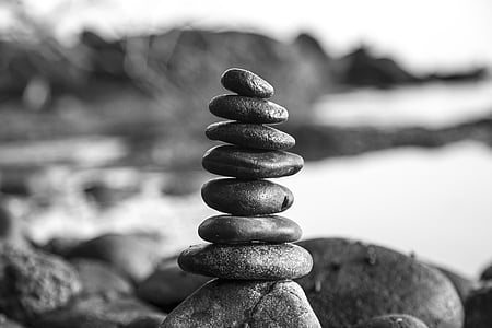 grayscale photo of stones stacked together