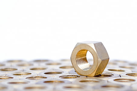 gold-colored metal hex nut
