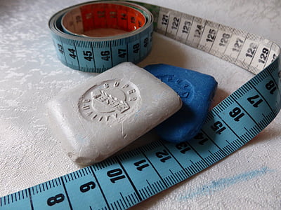blue tape measure on top of white textile