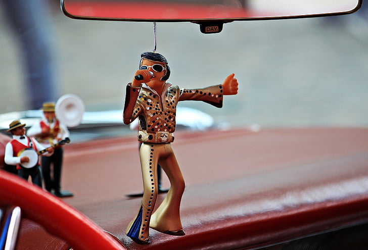 selective focus photography of Elvis Presley ornament hanging on rear view mirror