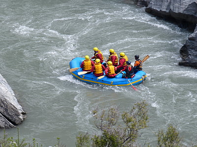 aerial photography of group of people riding inflatable boat