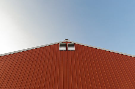 orange and white painted barn over blue and cloudy sky at daytime